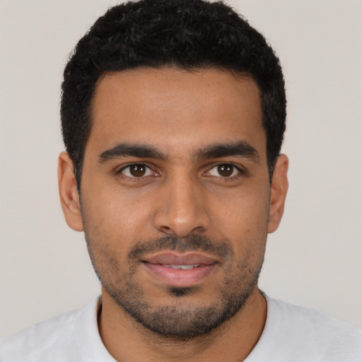 Joyful latino young-adult male with short  black hair and brown eyes