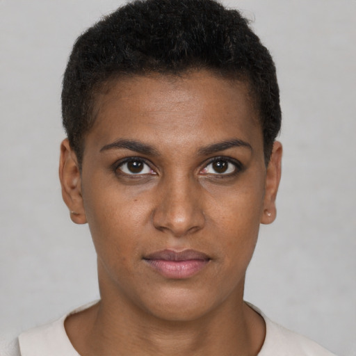 Joyful black young-adult female with short  brown hair and brown eyes