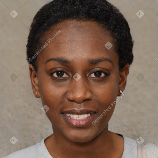 Joyful black young-adult female with short  black hair and brown eyes