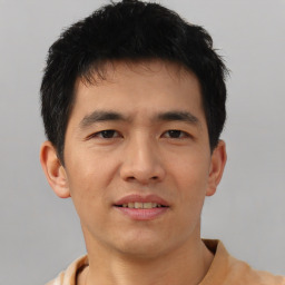 Joyful asian young-adult male with short  black hair and brown eyes