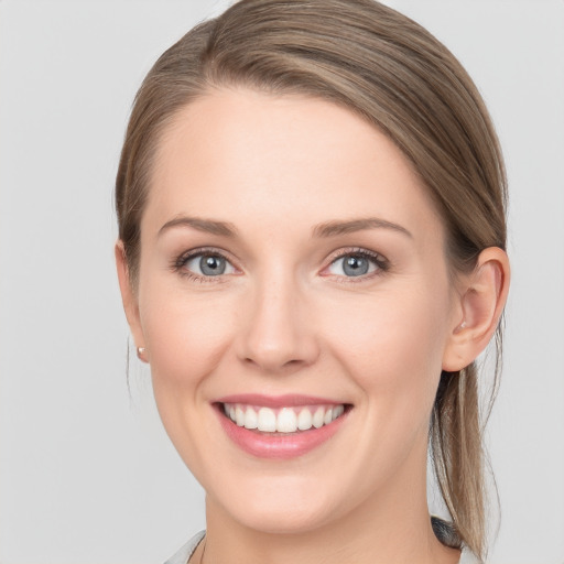 Joyful white young-adult female with long  brown hair and blue eyes