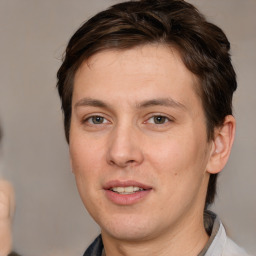 Joyful white adult male with medium  brown hair and brown eyes