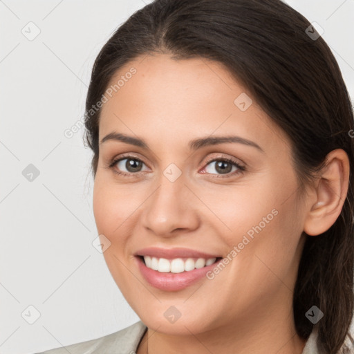 Joyful white young-adult female with medium  brown hair and brown eyes