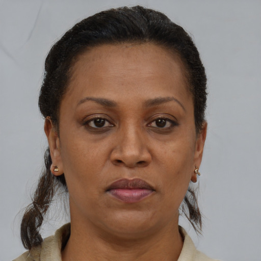 Joyful black adult female with short  brown hair and brown eyes