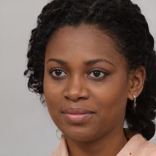 Joyful black young-adult female with medium  brown hair and brown eyes