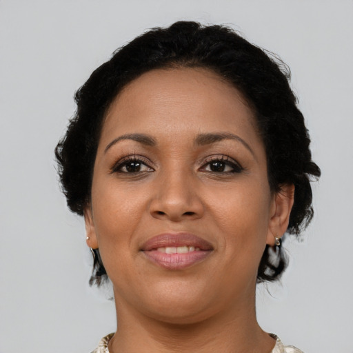 Joyful latino young-adult female with short  brown hair and brown eyes