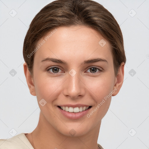 Joyful white young-adult female with short  brown hair and grey eyes