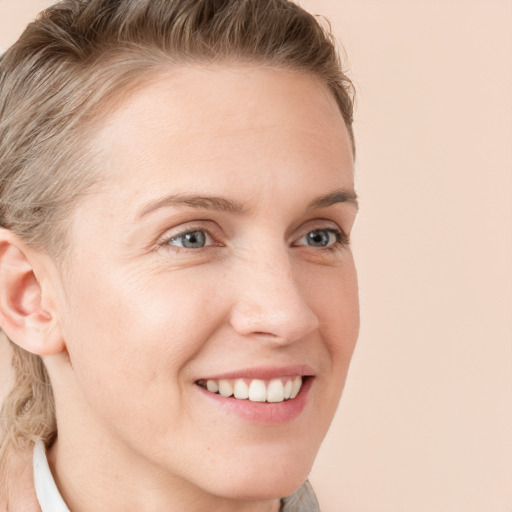 Joyful white young-adult female with medium  brown hair and blue eyes