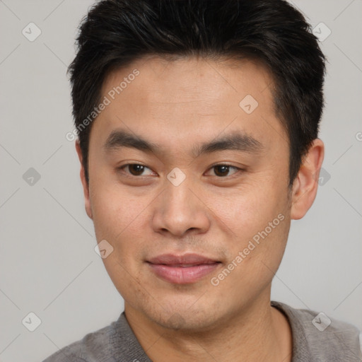 Joyful asian young-adult male with short  brown hair and brown eyes