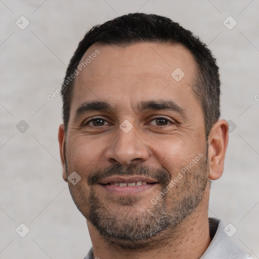 Joyful white adult male with short  black hair and brown eyes