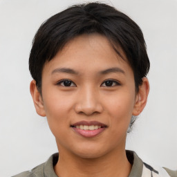 Joyful asian young-adult female with short  brown hair and brown eyes