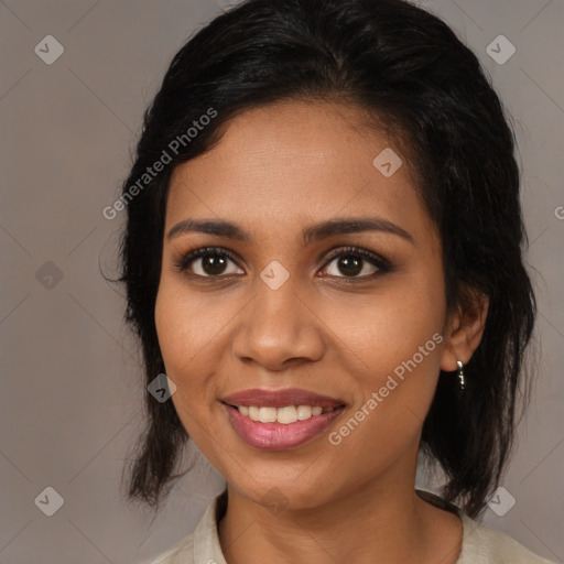 Joyful black young-adult female with medium  brown hair and brown eyes