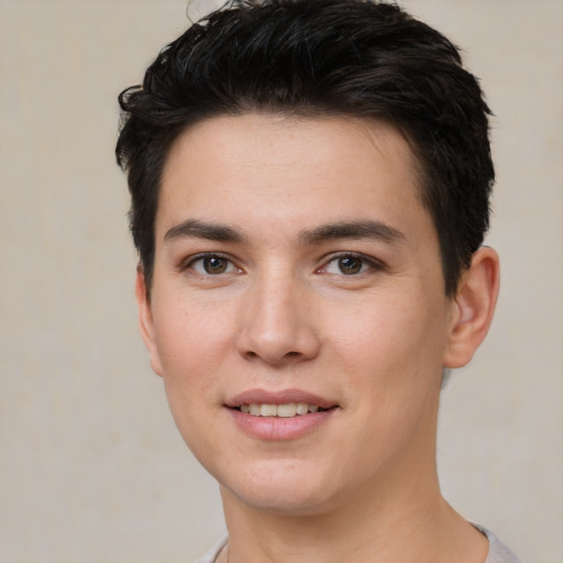 Joyful white young-adult male with short  black hair and brown eyes