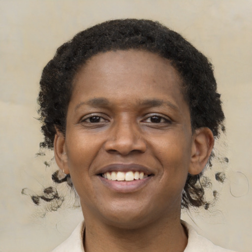 Joyful black young-adult female with medium  brown hair and brown eyes
