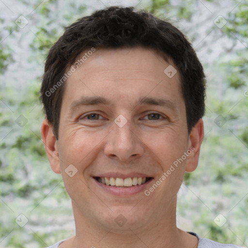 Joyful white adult male with short  brown hair and brown eyes