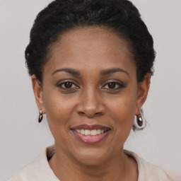 Joyful black young-adult female with short  brown hair and brown eyes