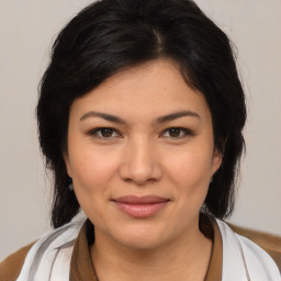 Joyful latino young-adult female with medium  brown hair and brown eyes