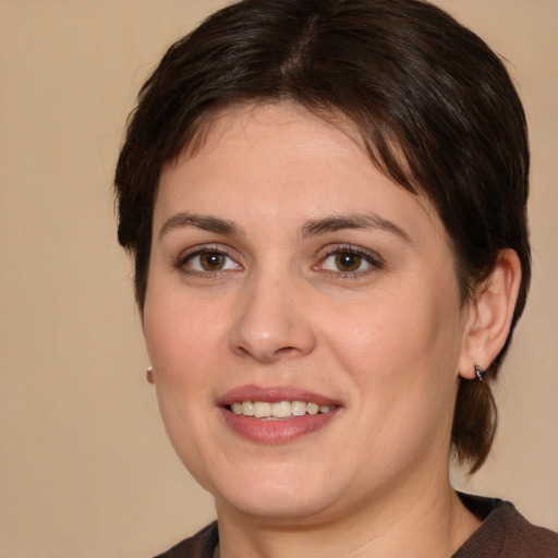 Joyful white young-adult female with medium  brown hair and brown eyes