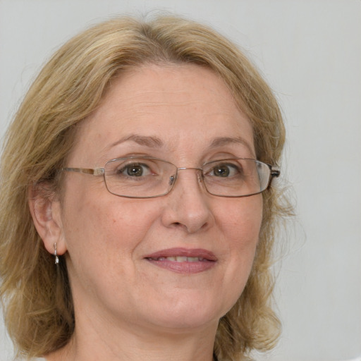 Joyful white middle-aged female with medium  brown hair and blue eyes