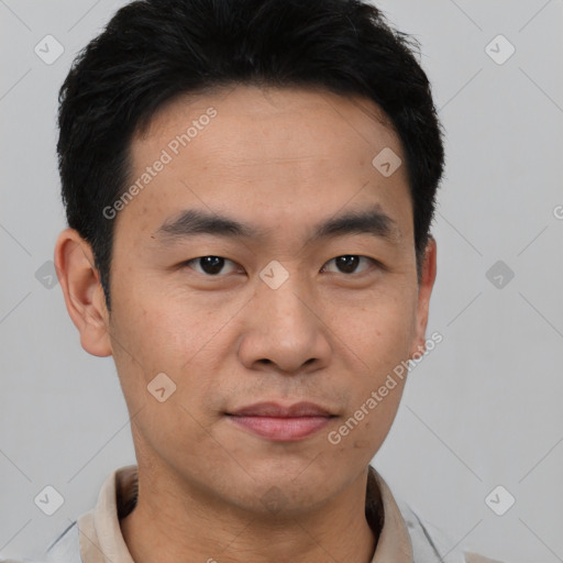 Joyful asian young-adult male with short  black hair and brown eyes