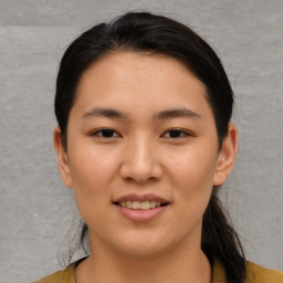 Joyful asian young-adult female with short  brown hair and brown eyes