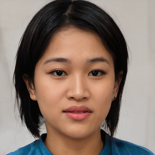 Joyful asian young-adult female with medium  black hair and brown eyes