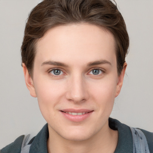 Joyful white young-adult female with short  brown hair and grey eyes