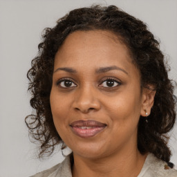 Joyful black young-adult female with medium  brown hair and brown eyes