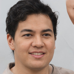 Joyful latino young-adult male with short  brown hair and brown eyes