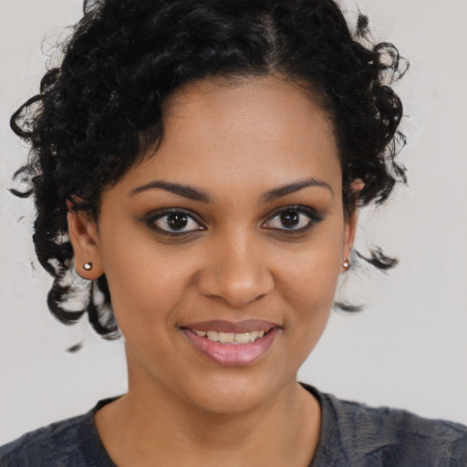 Joyful black young-adult female with medium  brown hair and brown eyes