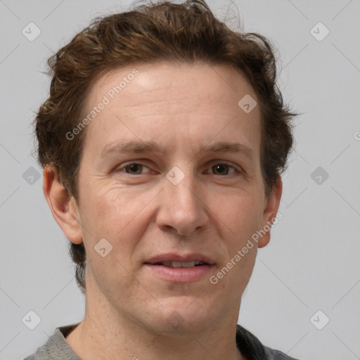 Joyful white adult male with short  brown hair and grey eyes