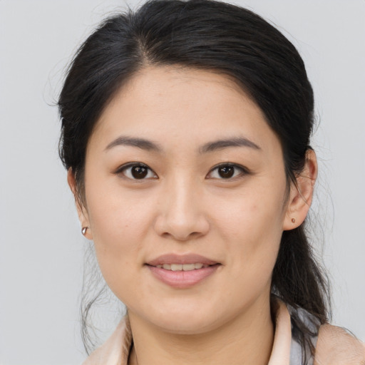 Joyful asian young-adult female with medium  brown hair and brown eyes