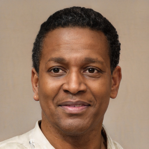 Joyful latino adult male with short  black hair and brown eyes