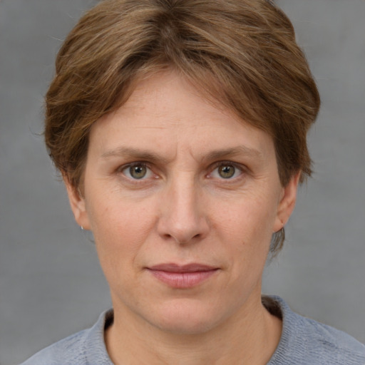 Joyful white adult female with short  brown hair and grey eyes