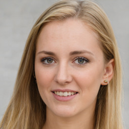 Joyful white young-adult female with long  brown hair and blue eyes