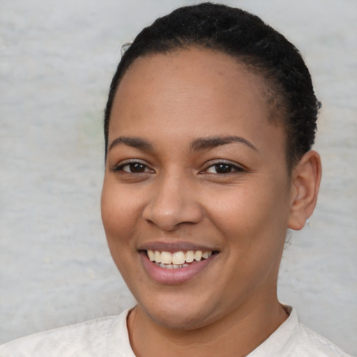 Joyful latino young-adult female with short  black hair and brown eyes