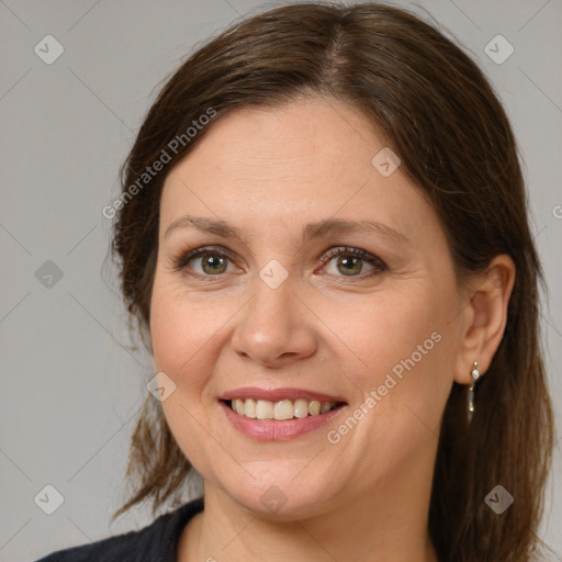 Joyful white adult female with medium  brown hair and brown eyes