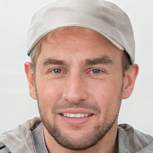 Joyful white adult male with short  brown hair and brown eyes