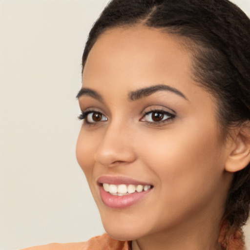 Joyful latino young-adult female with medium  brown hair and brown eyes