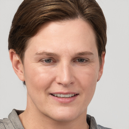 Joyful white adult female with short  brown hair and grey eyes