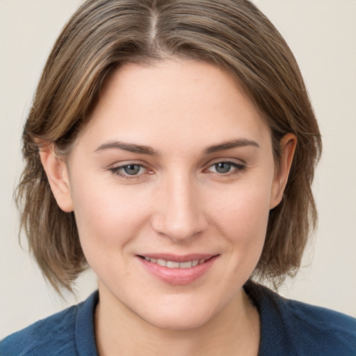 Joyful white young-adult female with medium  brown hair and blue eyes