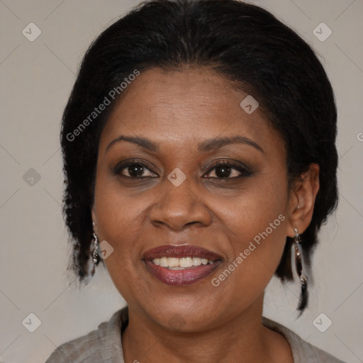 Joyful black adult female with medium  brown hair and brown eyes