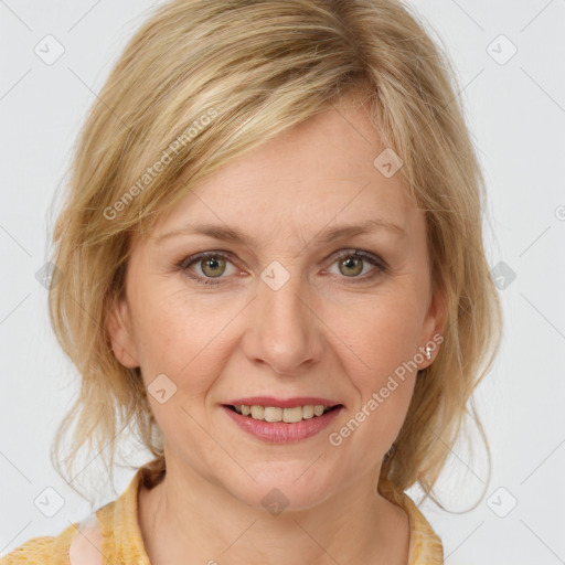 Joyful white adult female with medium  brown hair and blue eyes