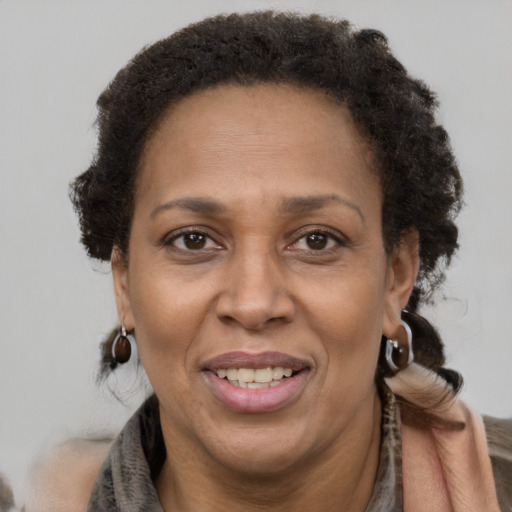 Joyful latino adult female with short  brown hair and brown eyes