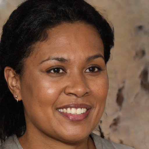 Joyful black young-adult female with medium  brown hair and brown eyes