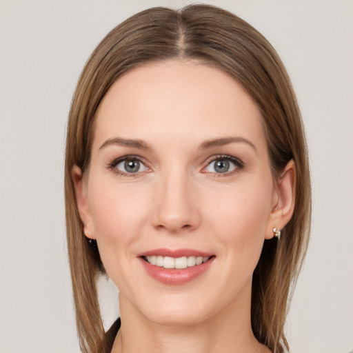 Joyful white young-adult female with long  brown hair and grey eyes