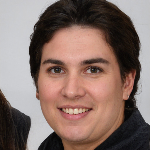 Joyful white young-adult female with medium  brown hair and brown eyes