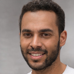 Joyful white young-adult male with short  black hair and brown eyes