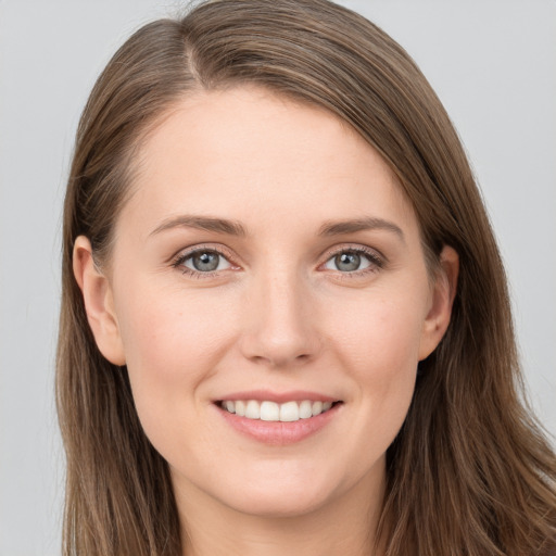 Joyful white young-adult female with long  brown hair and grey eyes