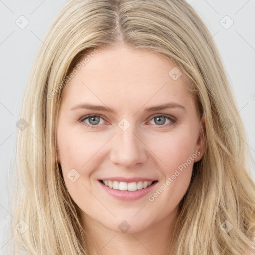 Joyful white young-adult female with long  brown hair and blue eyes